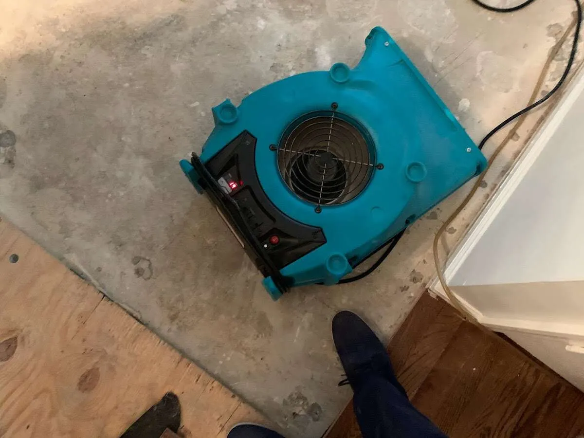 Air mover drying subfloor during Leak Detection & Repair in Ojus